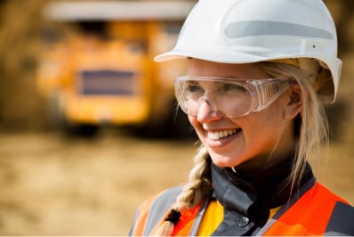 headshot of employee wearing hard hat and safety goggles